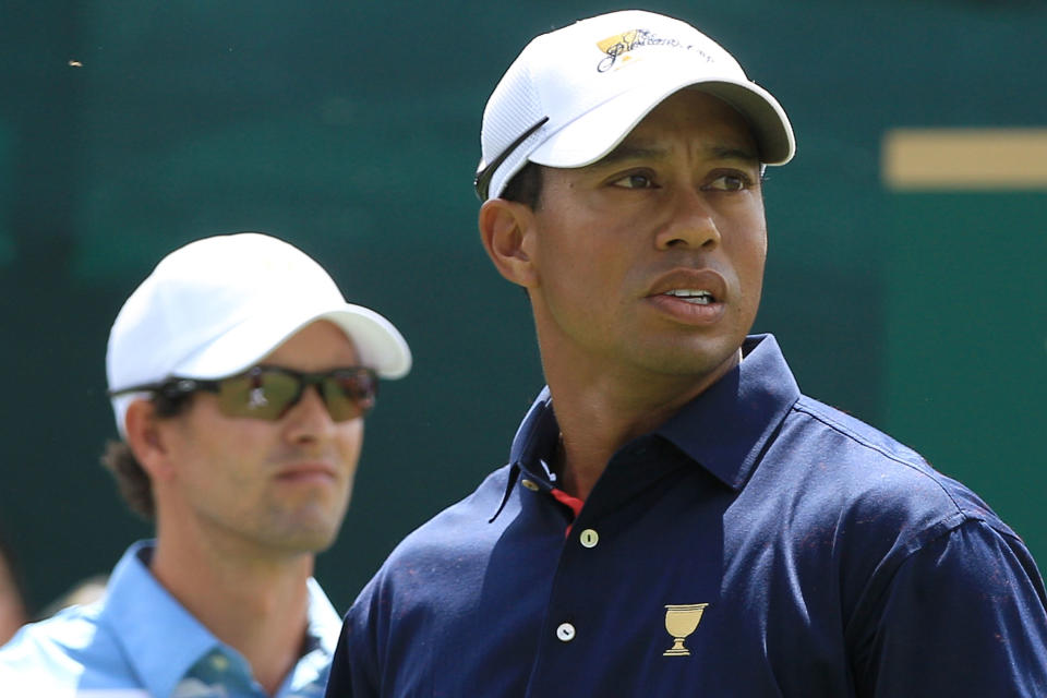 MELBOURNE, AUSTRALIA - NOVEMBER 17: Tiger Woods of the U.S. Team (R) and Adam Scott of the International Team (L) look on from the first tee during the Day One Foursome Matches of the 2011 Presidents Cup at Royal Melbourne Golf Course on November 17, 2011 in Melbourne, Australia. (Photo by Mark Dadswell/Getty Images)