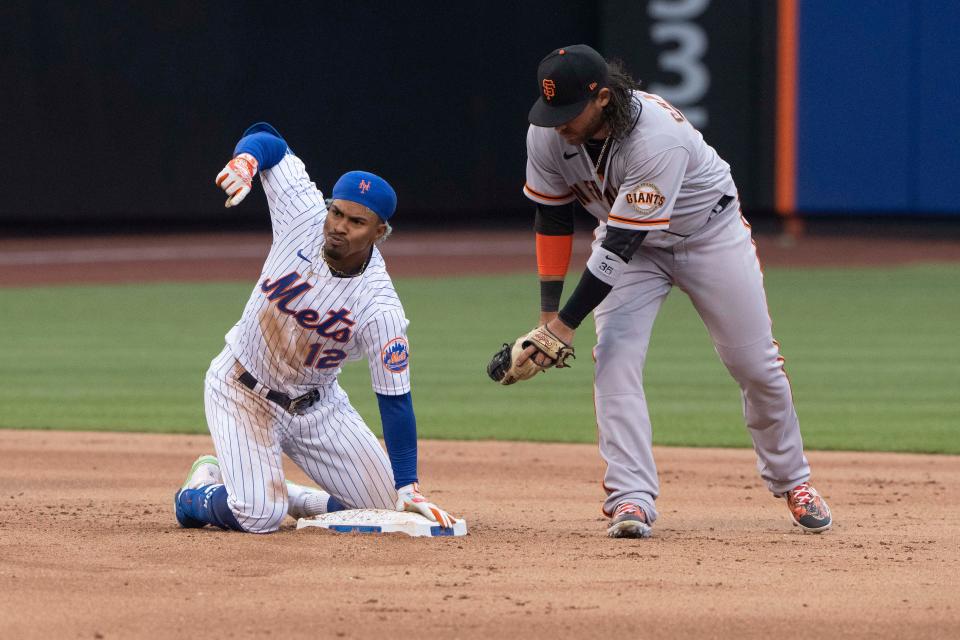 New York Mets shortstop Francisco Lindor (12) reacts to hitting an RBI double with San Francisco Giants shortstop Brandon Crawford (35) during the fifth inning at Citi Field.