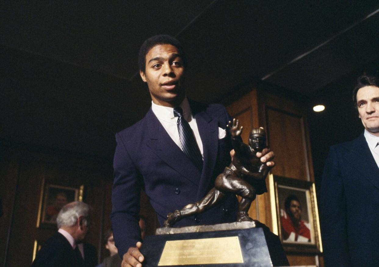 Marcus Allen of the USC Trojans, poses with the coveted Heisman Trophy