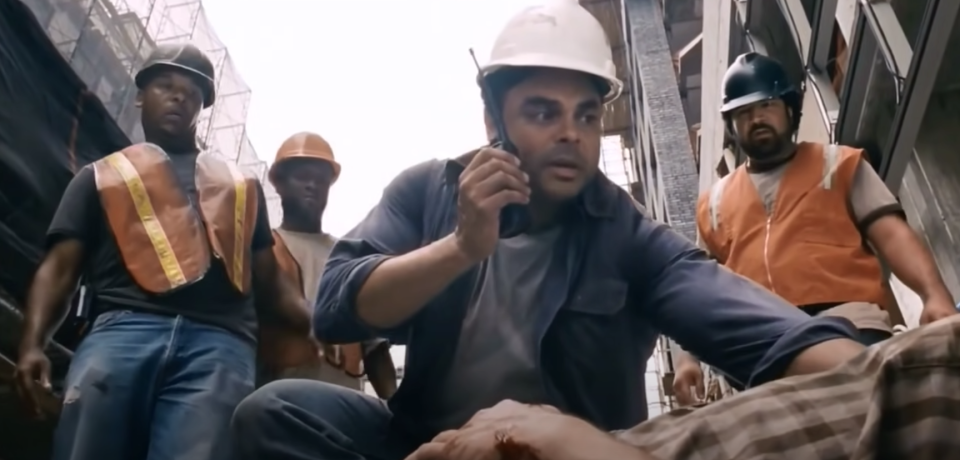 A construction worker radios in for help