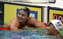 Kylie Masse of Canada, left, after the Women 50m Backstroke final at the 19th FINA World Championships in Budapest, Hungary, Wednesday, June 22, 2022. (AP Photo/Anna Szilagyi)