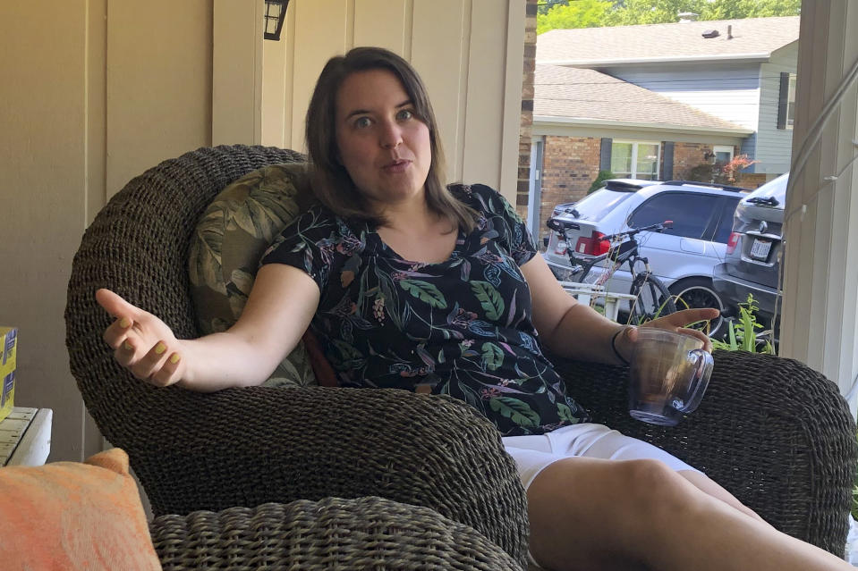 In this July 17, 2020, photo Andrea Granieri, a lifelong Republican, talks about her opposition to President Donald Trump as she sits on her front porch in the Cincinnati suburb of Anderson Township. (AP Photo/Dan Sewell)