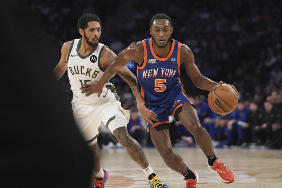 New York Knicks guard Immanuel Quickley (5) drives to the basket against Milwaukee Bucks guard Cameron Payne during the first half of an NBA basketball game in New York, Saturday, Dec. 23, 2023. (AP Photo/Peter K. Afriyie)