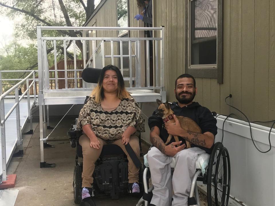 Kierra Livingston, left, and Izzy Vigil are pictured with their dog Pablo in front of their newly built ramp.