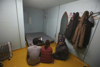 Cambodian workers speak during an online interview in a shipping container that is used as their home installed at a farm in Pocheon, South Korea on Feb. 8, 2021. Amid a sea of greenhouses near South Korea’s ultra-modern capital, hundreds of migrant workers from across Asia toil isolated and unprotected by labor laws. (AP Photo/Ahn Young-joon)