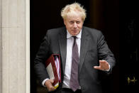 FILE - In this Sept. 15, 2021, file photo, Britain's Prime Minister Boris Johnson leaves 10 Downing Street as he makes his way to Parliament to attend the weekly Prime Minister Questions session, in London. Britain's Conservative government is hoping a combination of relatively high vaccination rates and common-sense behavior will keep a lid on coronavirus infections this fall and winter and avoid the need for restrictive measures. That plan employs a lighter touch than most nations. (AP Photo/Alberto Pezzali, File)