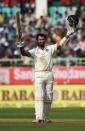 India's Cheteshwar Pujara celebrates reaching his century on the first day of the second Test against England in Vishakhapatnam on November 17, 2016