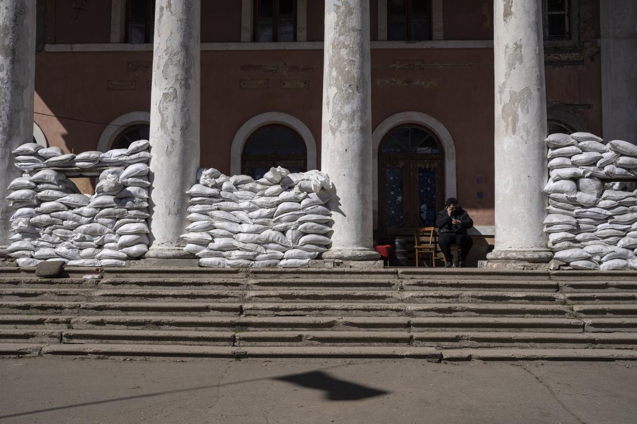 Sandbags, for protection cover the entrance of a building, at a Ukrainian volunteer center in Mykolaiv, southern Ukraine, on Monday, March 28, 2022. Ukrainian volunteers have set up a center to supply army and civilians with clothes, food, medicines and makeshift bullet proof vests. (AP Photo/Petros Giannakouris)