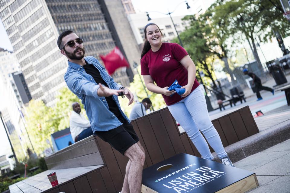 Thomas Gregovich and Sarah Barford play cornhole.