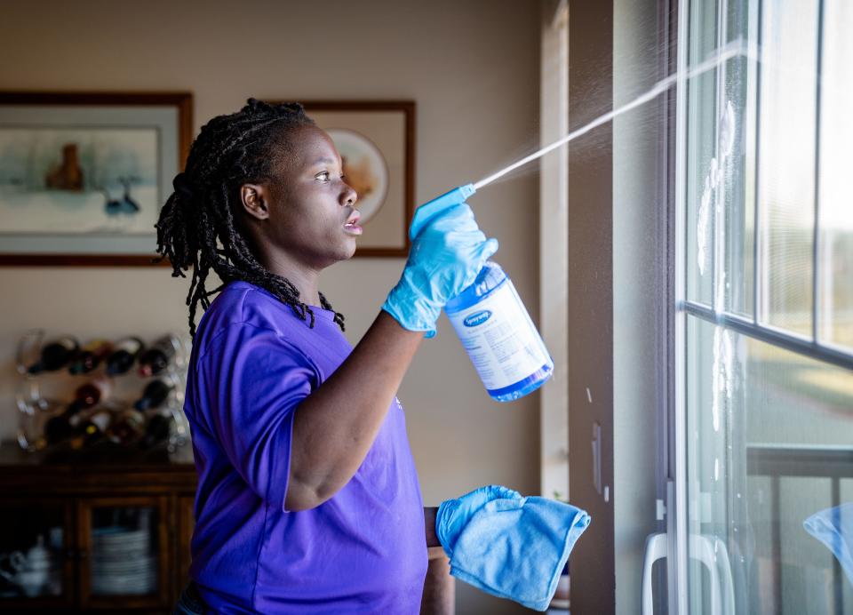 Lilian Okech cleans a unit at the Vintage Cooperative of Altoona, Wednesday, Dec. 7, 2022.