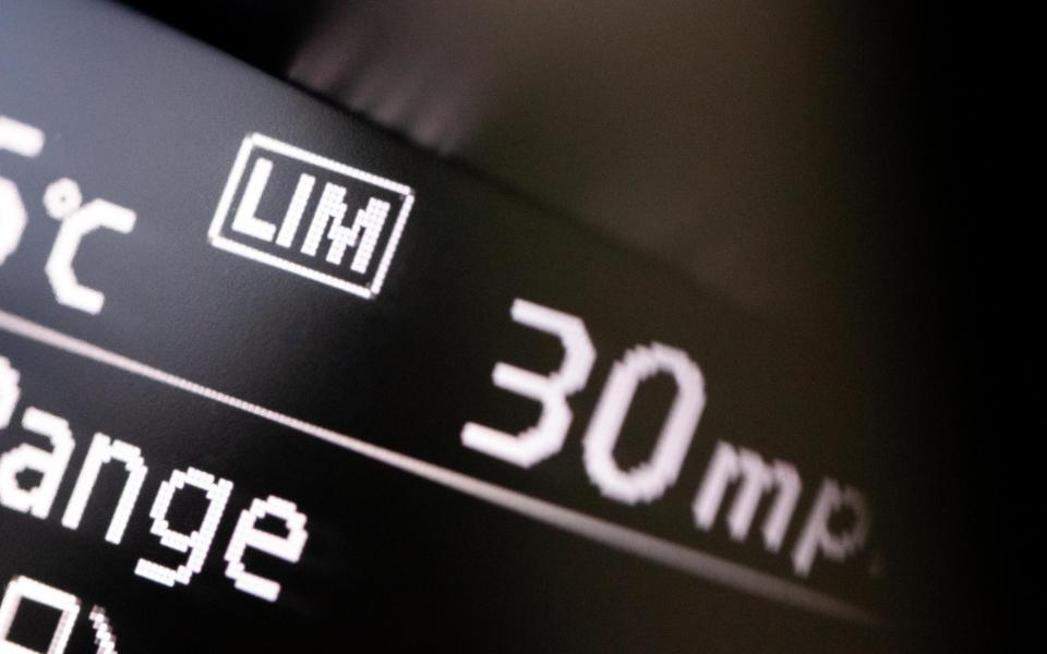 A close-up photo of a digital display on a car dashboard, with the letters LIM denoting that the system is switched on