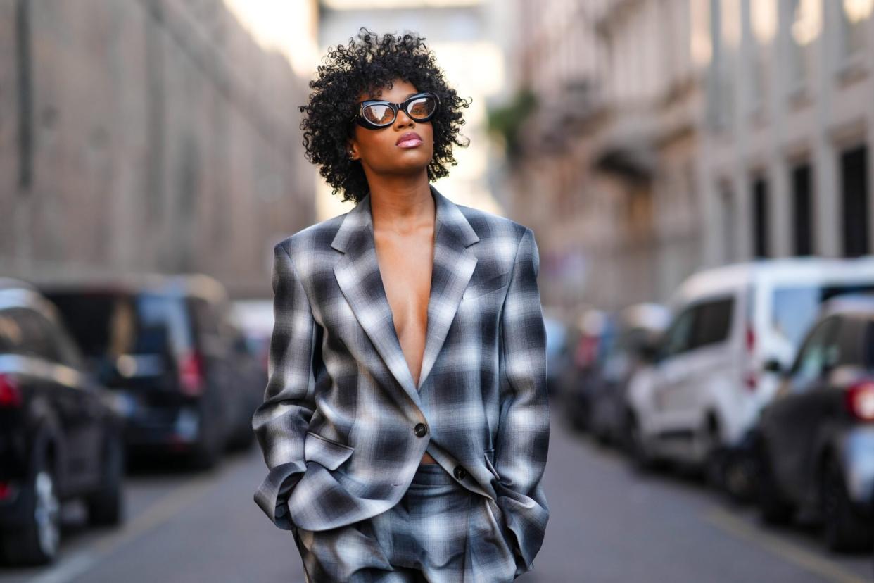 Woman in plaid suit with natural texture hair