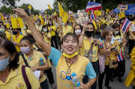 Supporters of the Thai monarchy wave national flags and sing during a rally at Lumphini park in central Bangkok, Thailand, Tuesday, Oct. 27, 2020. Hundreds of royalists gathered to oppose pro-democracy protesters' demands that the prime minister resign, constitution be revised and the monarchy be reformed in accordance with democratic principles. (AP Photo/Gemunu Amarasinghe)