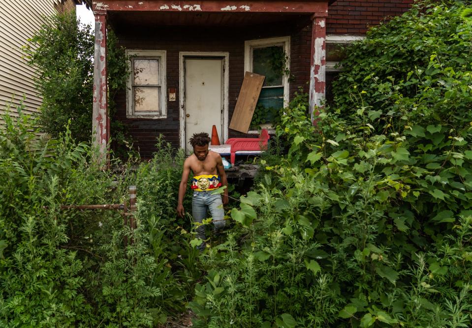 Chesse da Chosen One, of Lincoln Park, walks back towards the ring after taking a break in front of an abandoned home after defeating Ruben Gonzalez of Lincoln Park during a title fight on a hot summer day on Sunday, June 6, 2021 during a Pick Your Poison Detroit event in Detroit's Delray neighborhood.