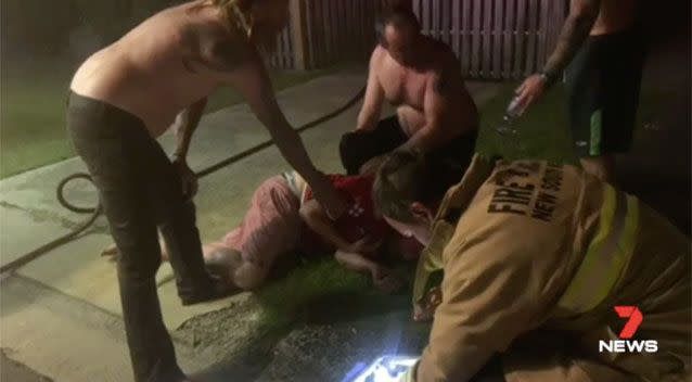 Robert being treated at the scene after trying to save his neighbour. Source: 7News