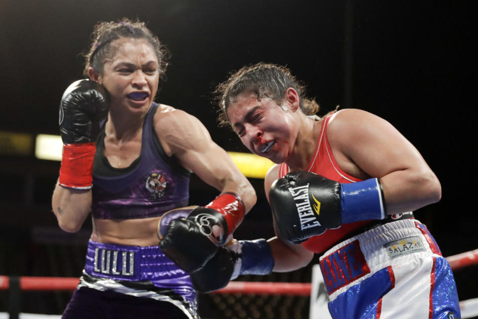 Australia's Louisa Hawton, left, hits Lorraine Villalobos during their WBC atomweight interim title boxing match, Saturday, Dec. 8, 2018, in Carson, Calif. (AP Photo/Chris Carlson)