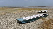 <p>Tourist boats stand on a dried out portion of wetlands at Nalsarovar Bird Sanctuary, some 70kms from Ahmedabad on May 29, 2016. Migratory flamingoes are being encouraged to stay at the wetlands in the western state of Gujarat as the locating of shoals of fish which form the diet of the flamingos, is made easier with the falling levels of water which are the result of drought conditions which are prevailing across northern India. </p>