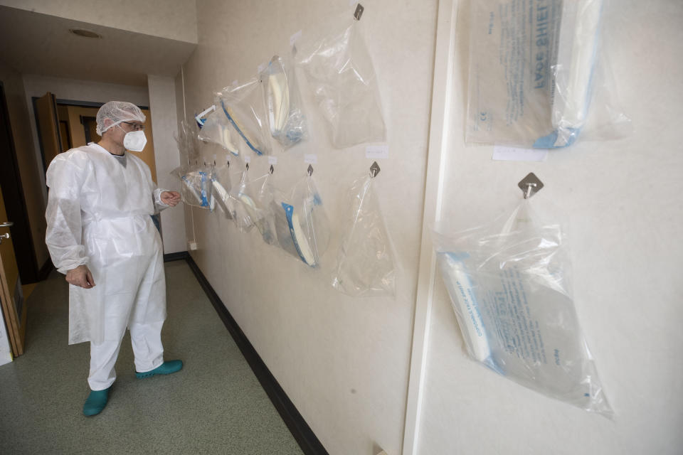 Dr. Gabriele Zanolini, director of the main covid ward at Mellino Mellini hospital in Chiari, northern Italy, checks protective equipment, Monday, March 8, 2021. The 160-bed hospital in the Po River Valley town of Chiari has no more beds for patients stricken with the highly contagious variant of COVID-19 first identified in Britain, and which now has put hospitals in Italy’s northern Brescia province on high alert. (AP Photo/Luca Bruno)