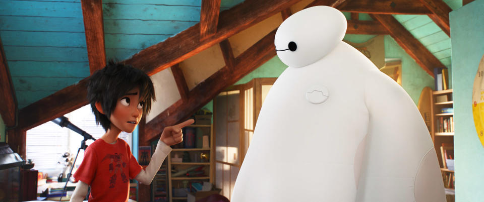 Hiro Hamada points at Baymax in an attic room, discussing something from the movie "Big Hero 6"