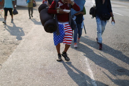 Central American migrants walk during their journey towards the United States, in Mapastepec, Mexico April 20, 2019. REUTERS/Jose Cabezas