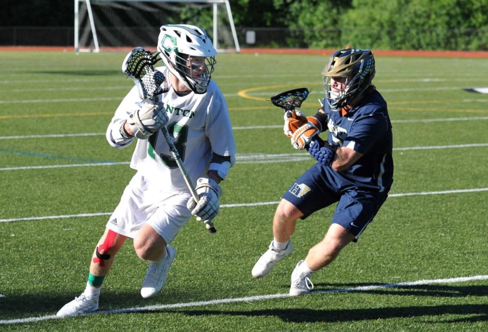 Canton's Brendan Tourgee, left, tries to get around Hanover defender DJ Stronjy during the boys lacrosse Divison 2 South Semifinal at Canton High School, Thursday, June 24, 2021.