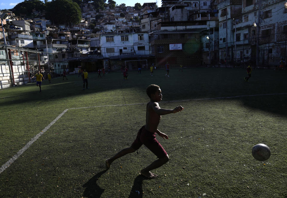 A boy attends a soccer training class at the Professor Mateia soccer school in the Morro da Mineira favela, Rio de Janeiro, Brazil, Friday, Nov. 18, 2022. Brazil will go to this year's World Cup as the top-rated team after extending its lead over second-place Belgium in the latest FIFA rankings. The World Cup starts on Nov. 20. (AP Photo/Silvia Izquierdo)