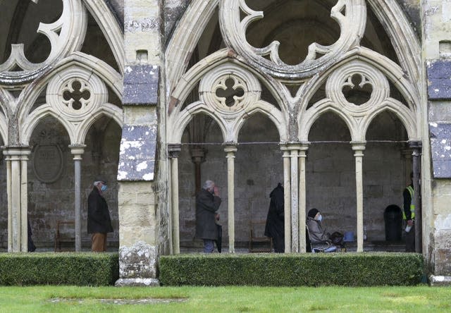 People queue outside Salisbury Cathedral, Wiltshire, to receive a jab (Steve Parsons/PA)