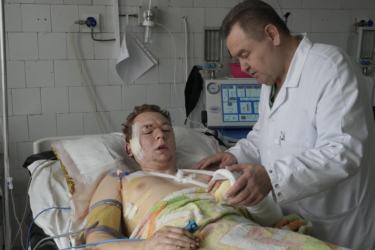 A medical worker attends to a wounded man at a hospital in Brovary, outside Kyiv, Ukraine, on Tuesday, March 1, 2022. Russian shelling pounded civilian targets in Ukraine's second-largest city, Kharkiv, again Tuesday and a 40-mile convoy of tanks and other vehicles threatened the capital, tactics Ukraine's embattled president said were designed to force him into concessions in Europe's largest ground war in generations.