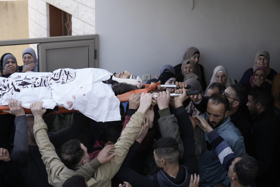 Palestinian mourners carry Mohammed Daraghmeh, 26, a co-founder of the local branch of the Islamic Jihad militant group, during his funeral in the West Bank town of Tubas, Tuesday, Feb. 27, 2024. Israeli troops shot and killed three Palestinian men including Daraghmeh, in the northern town of Tubas, early Tuesday, Palestinian health authorities said. Thee was no immediate comment from the Israeli military. (AP Photo/Majdi Mohammed)