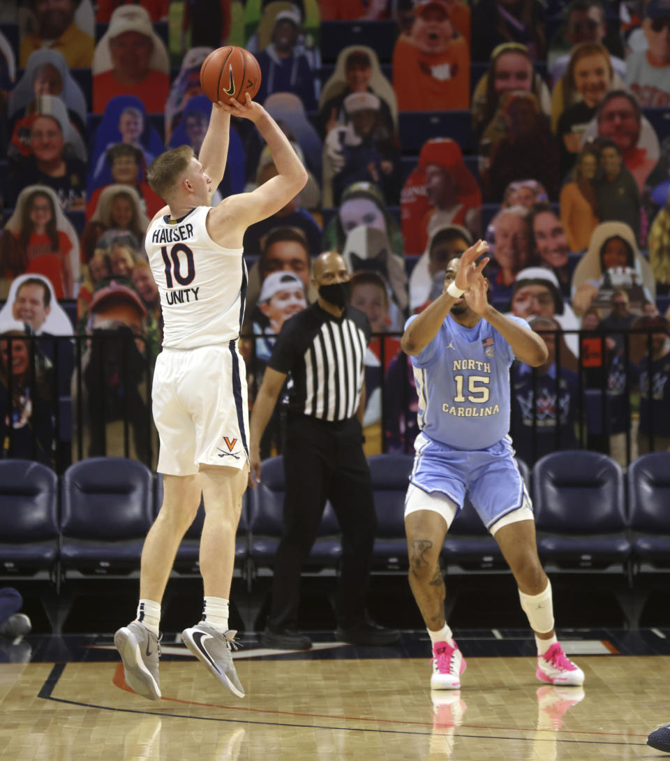 Virginia forward Sam Hauser (10) shoots over North Carolina forward Garrison Brooks (15) during an NCAA college basketball game Saturday, Feb. 13, 2021, in Charlottesville, Va. (Andrew Shurtleff/The Daily Progress via AP, Pool)