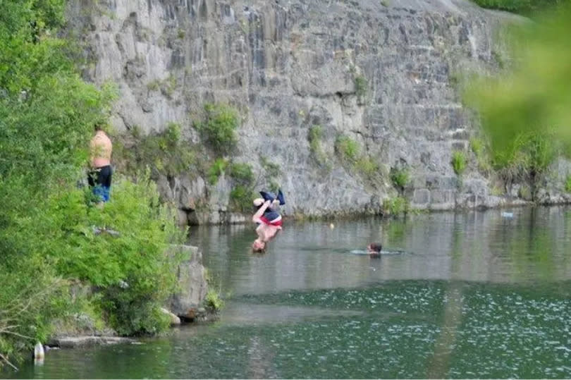 Youngsters jumping into the water at East Quarry