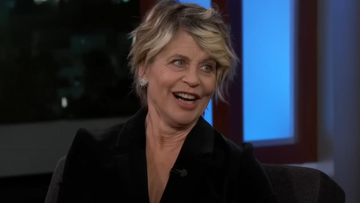  A screenshot of Linda Hamilton smiling on Jimmy Kimmel Live. 