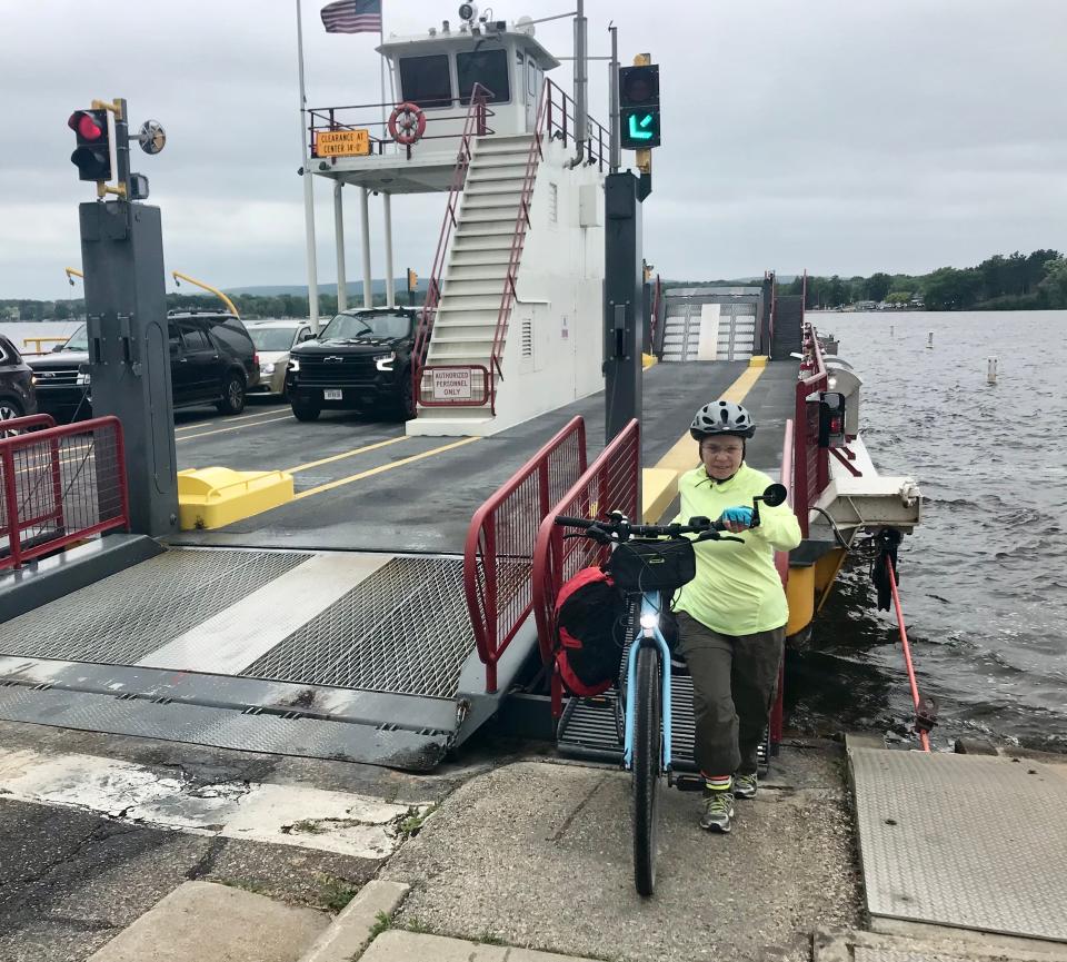 Sonja Gurda pushes her bicycle off the Merrimac Ferry, which crosses the Wisconsin River between Sauk and Columbia counties.