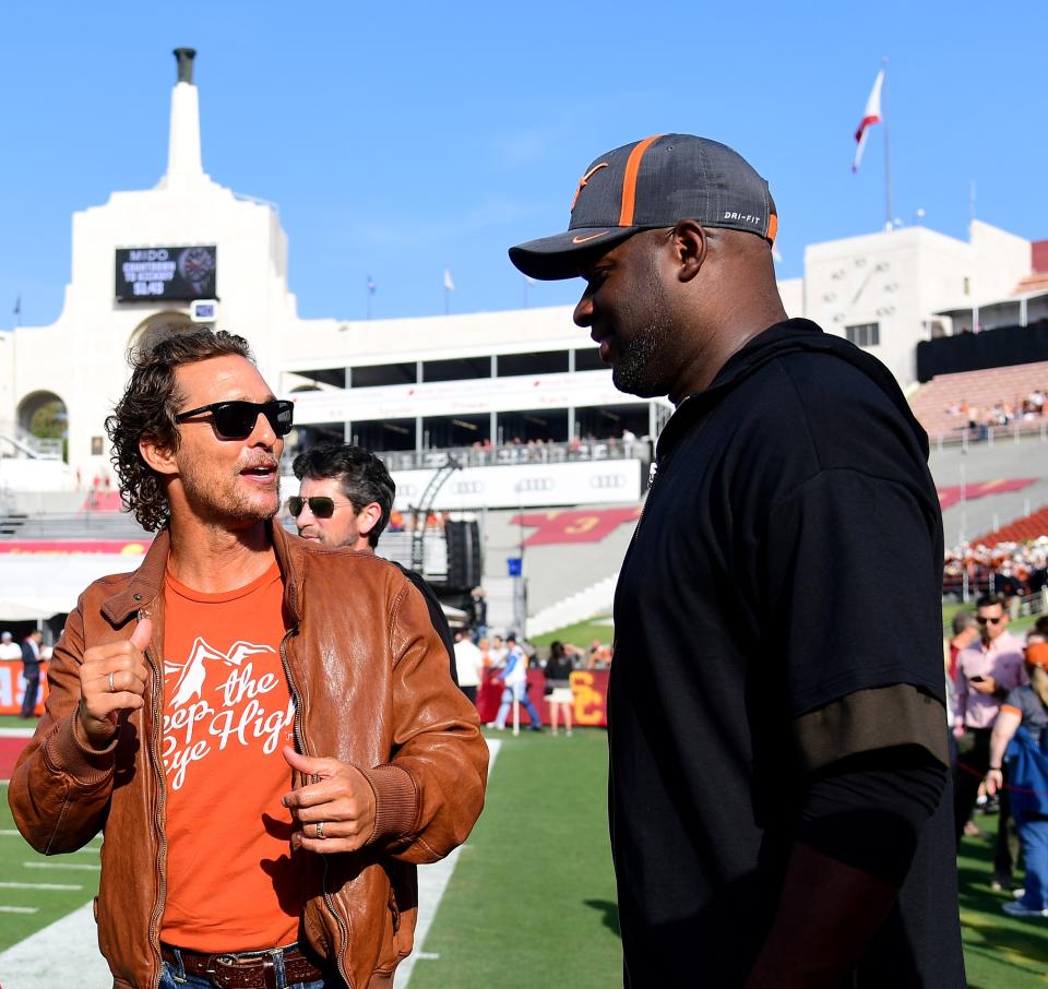 Actor Matthew McConaughey and quarterback Vince Young talk on the sidelines before the game between the Texas Longhorns and the USC Trojans at Los Angeles Memorial Coliseum in 2017. (Getty Images)