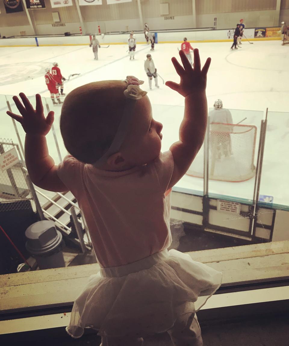 Chloe Wiegand banging on the glass at a hockey game