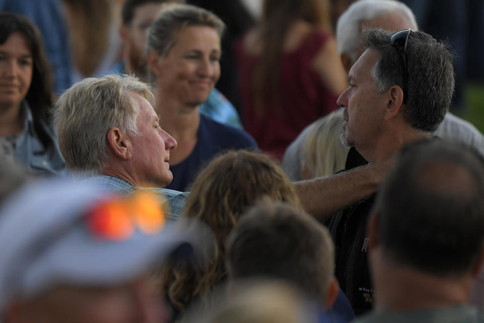 Glen Fritzler, left, co-owner of Truth Aquatics and the dive boat Conception, consoles attendees during a vigil Friday, Sept. 6, 2019, in Santa Barbara, Calif., for the victims who died aboard the dive boat Conception. The Sept. 2 fire took the lives of 34 people on the ship off Santa Cruz Island off the Southern California coast near Santa Barbara. (AP Photo/Mark J. Terrill)