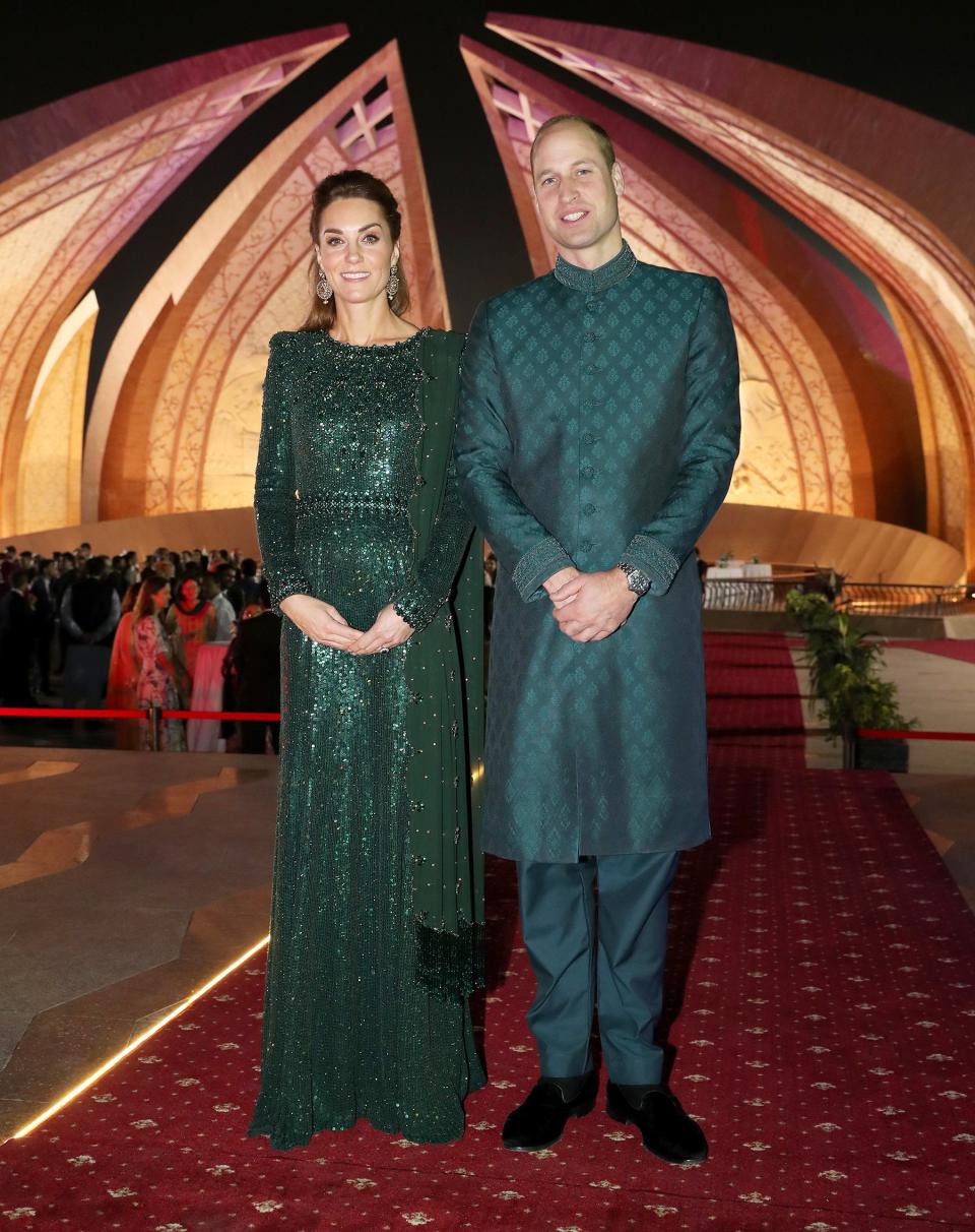 Kate and Prince William went full glam for an evening reception held in their honor at the iconic Pakistan Monument. The royal dad took a break from his usual suits to <a href="https://people.com/royals/why-prince-william-is-making-headlines-for-his-fashion-for-the-first-time-in-pakistan/" rel="nofollow noopener" target="_blank" data-ylk="slk:wear a traditional sherwani;elm:context_link;itc:0;sec:content-canvas" class="link ">wear a traditional sherwani</a>, a long coat-like garment worn for formal occasions. William opted to wear green, paying tribute to the color of his host country’s flag. Kate also wore the national color, choosing a sparkling deep emerald gown by Jenny Packham.