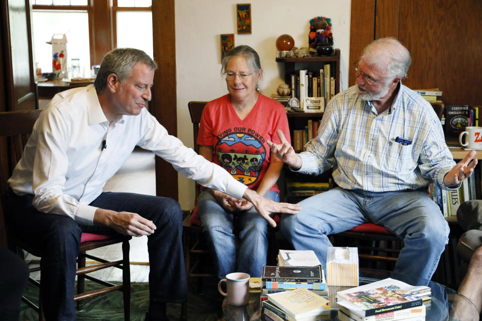 Democratic presidential candidate New York Mayor Bill de Blasio, left, talks with George Naylor, right, during a meeting with Greene County small family farmers, Friday, May 17, 2019, in Churdan, Iowa. (AP Photo/Charlie Neibergall)