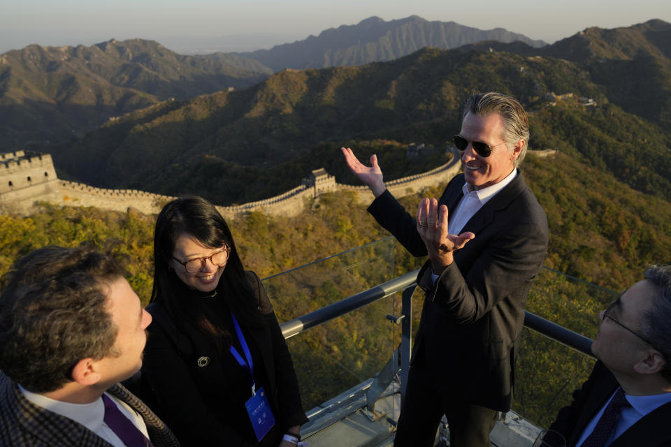 California Gov. Gavin Newsom chats with attendees at a reception during a visit to the Mutianyu Great Wall on the outskirts of Beijing, Thursday, Oct. 26, 2023. Newsom is on a weeklong tour of China where he is pushing for climate cooperation. His trip as governor, once considered routine, is drawing attention as it comes after years of heightening tensions between the U.S. and China. (AP Photo/Ng Han Guan)