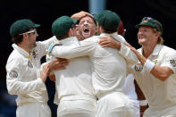 Australian bowler Michael Hussey (C) celebrates with teammates the wicket of West Indies batsmen Darren Bravo by lbw during the third day of the second-of-three Test matches between Australia and West Indies April 17, 2012 at Queen's Park Oval in Port of Spain, Trinidad. AFP PHOTO/Stan HONDA (Photo credit should read STAN HONDA/AFP/Getty Images)