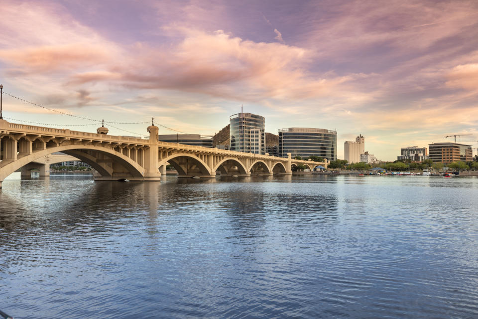 Cityscape shore view of downtown Tempe Arizona USA over the Salt River and Mill Avenue Bridge