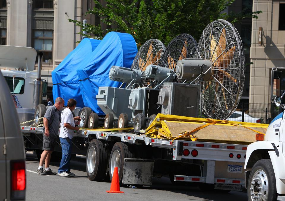 Crews unwrap giant fans on Lafayette near Shelby prior to afternoon shooting. Filming for the superhero movie "Batman v. Superman: Dawn of Justice" took place in downtown Detroit on Saturday, Aug. 9, 2014. Michigan's previous film incentive program was effectively cut in 2015.