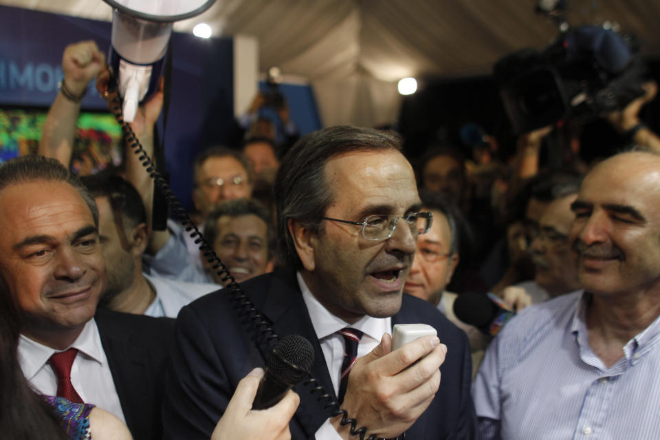 Leader of the New Democracy conservative party Antonis Samaras, speaks to supporters at an election kiosk at Syntagma square in Athens, Sunday, June 17, 2012. The pro-bailout New Democracy party came in first Sunday in Greece's national election, and its leader has proposed forming a pro-euro coalition government.(AP Photo/Kostas Tsironis)