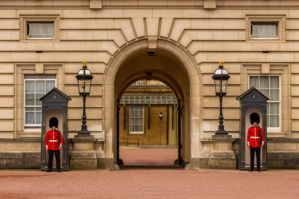 Two soldiers of Queen's Guard standing at the entrance to Buckingham Palace