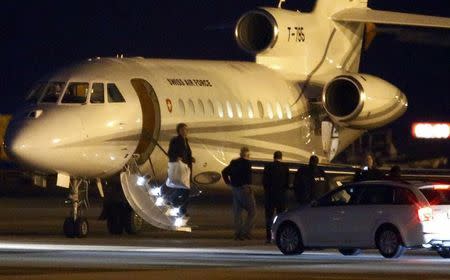 People walk off a plane carrying three Iranian-Americans, who left Tehran under a prisoner swap, after it landed at Cointrin airport in Geneva, Switzerland January 17, 2016. REUTERS/Denis Balibouse