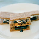 <p>Rich dark chocolate squares and banana slices put a delectably sweet twist on a classic campfire favorite. </p><strong>Recipe: <a rel="nofollow noopener" href="http://www.myrecipes.com/recipe/grilled-banana-smores" target="_blank" data-ylk="slk:Grilled Banana S'mores;elm:context_link;itc:0;sec:content-canvas" class="link ">Grilled Banana S'mores</a></strong>