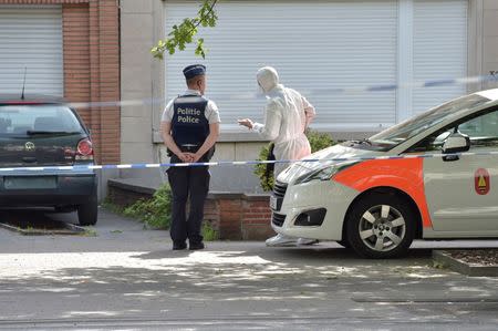 Belgian policemen chat next to a house after searching it, following yesterday's attack, in Brussels, Belgium June 21, 2017. REUTERS/Eric Vidal