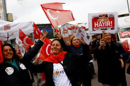 "Hayir", "No" in English, supporters hold Turkish flags and leaflets for the upcoming referendum at a campaign point in Istanbul, Turkey, March 31, 2017. REUTERS/Murad Sezer