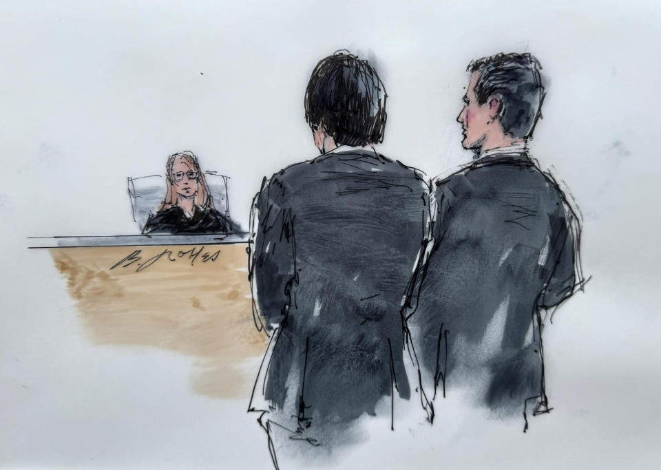 In this courtroom sketch, Ippei Mizuhara, front left, the former longtime interpreter for baseball player Shohei Ohtani, is joined by his attorney, Michael G. Freedman, in front of U.S. Magistrate Judge Maria A. Audero in Los Angeles on Friday, April 12, 2024. Mizuhara, charged with a single count of bank fraud, was ordered to undergo gambling addiction treatment. (Bill Robles via AP)