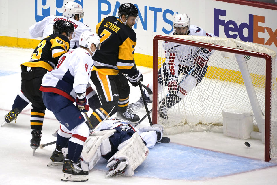 Pittsburgh Penguins' Colton Sceviour (7) puts the puck behind Washington Capitals goaltender Craig Anderson for a goal during the first period of an NHL hockey game in Pittsburgh, Tuesday, Jan. 19, 2021. (AP Photo/Gene J. Puskar)